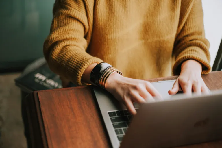 Person using a laptop to study an online course