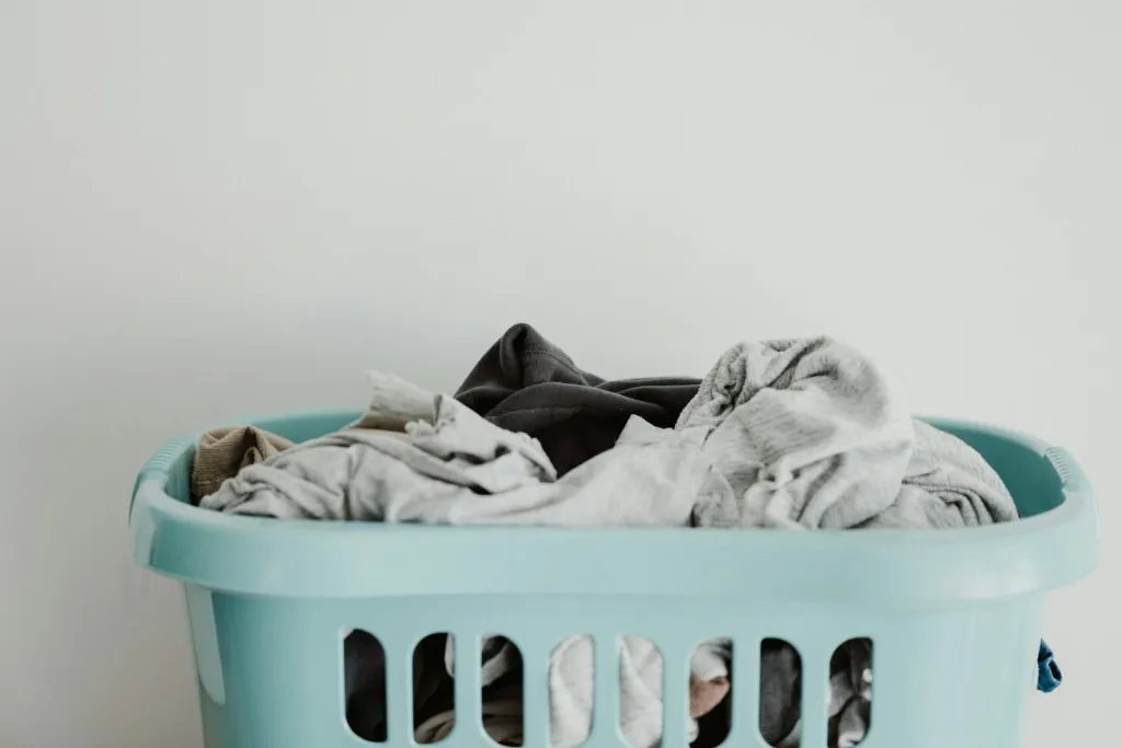 Clean white laundry in a blue laundry basket