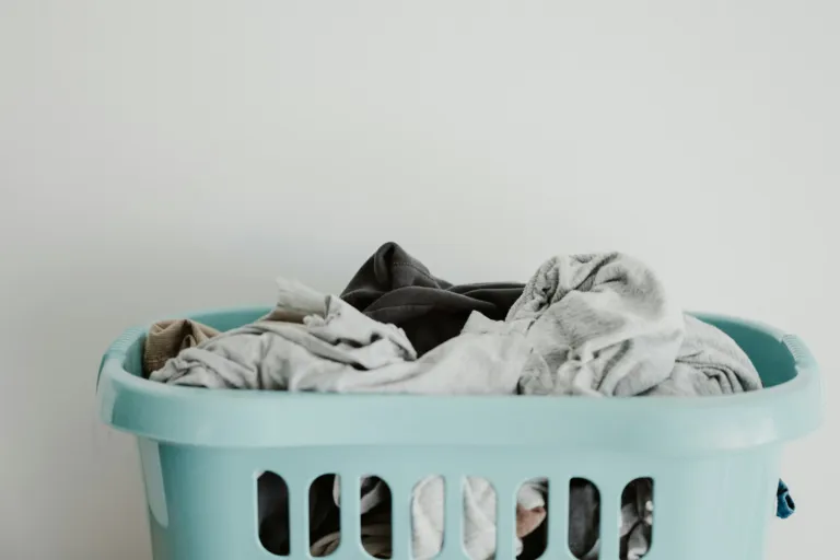 Clean white laundry in a blue laundry basket