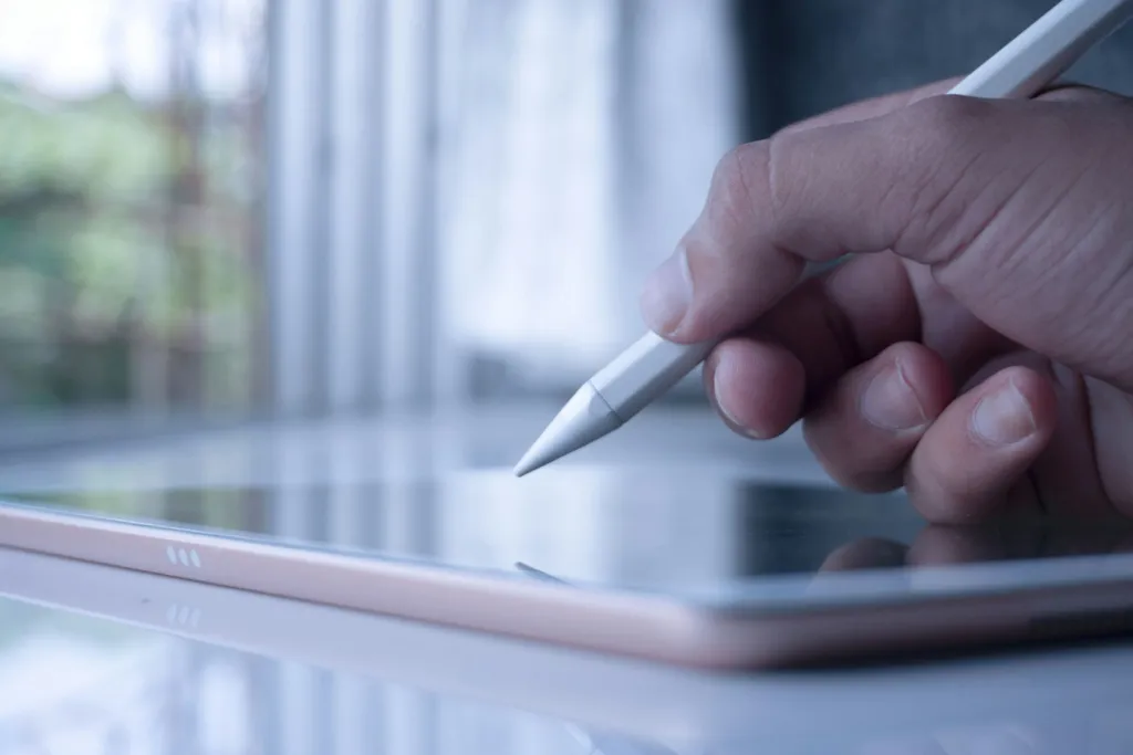 Student writing on a tablet with a stylus, the future of online math learning with Math Tutors.org