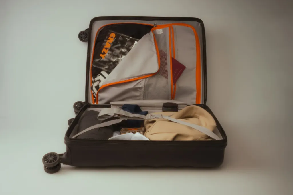 Open suitcase neatly packed with clothes and travel essentials